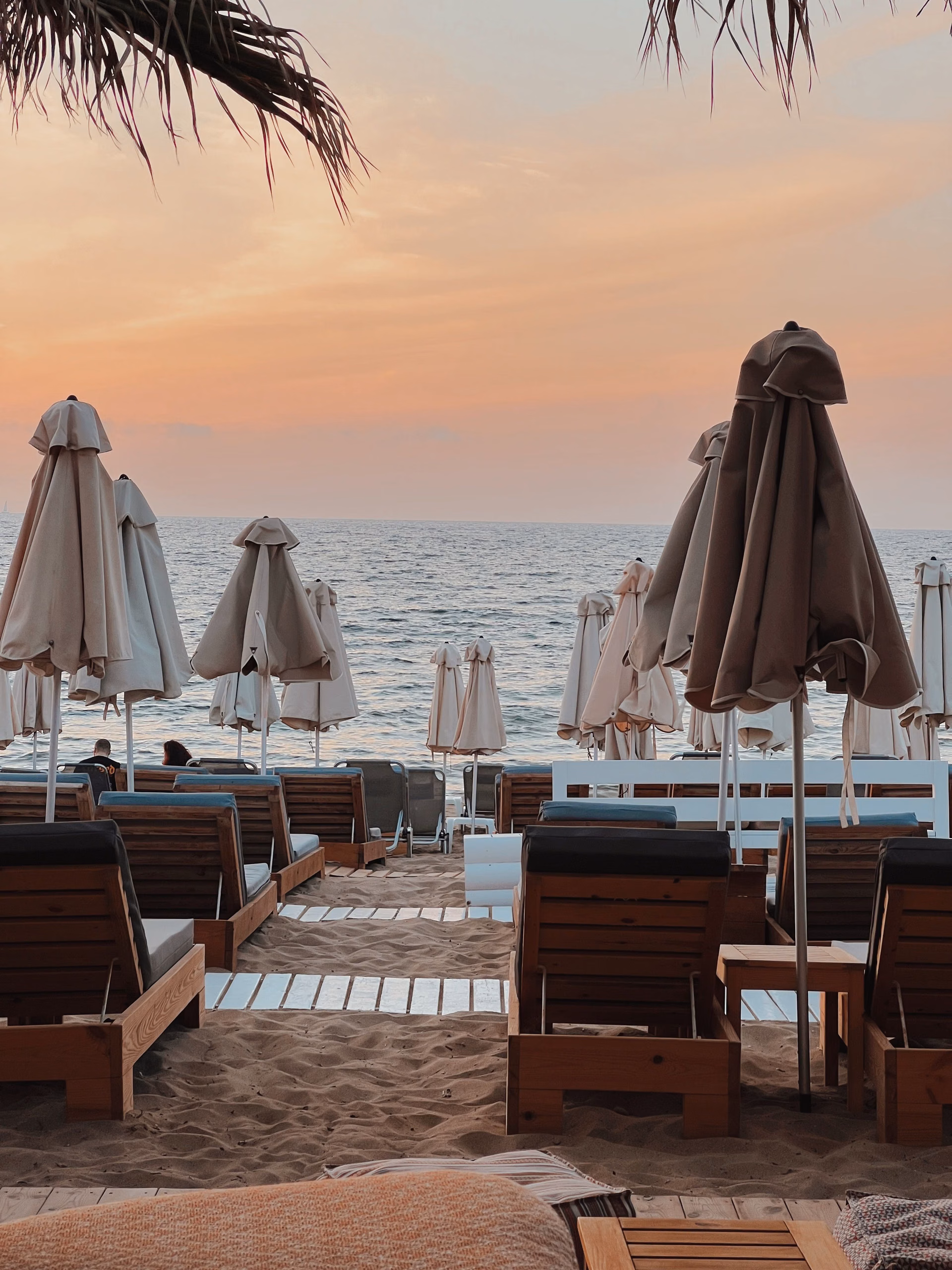 Beach lounge chairs and umbrellas at sunset, Cabo Real amenities, Cabo Corridor, Los Cabos