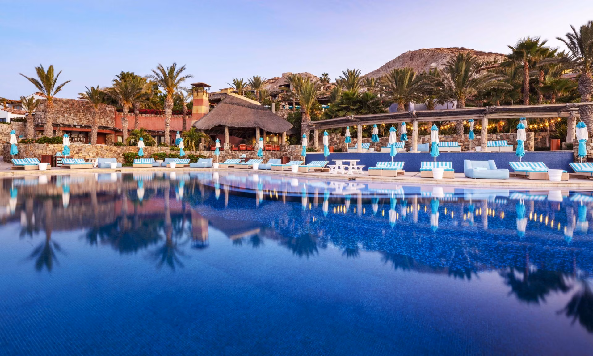 Golfers walking a sun-drenched fairway with ocean views, El Dorado Golf and Beach Club lifestyle, Los Cabos