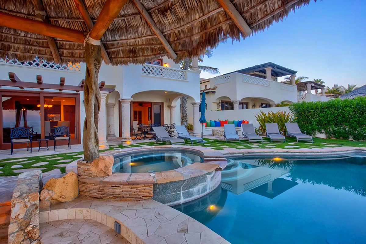 Beachfront infinity pool and lounge overlooking the Sea of Cortez at sunset, Encanto de la Laguna lifestyle, San José del Cabo
