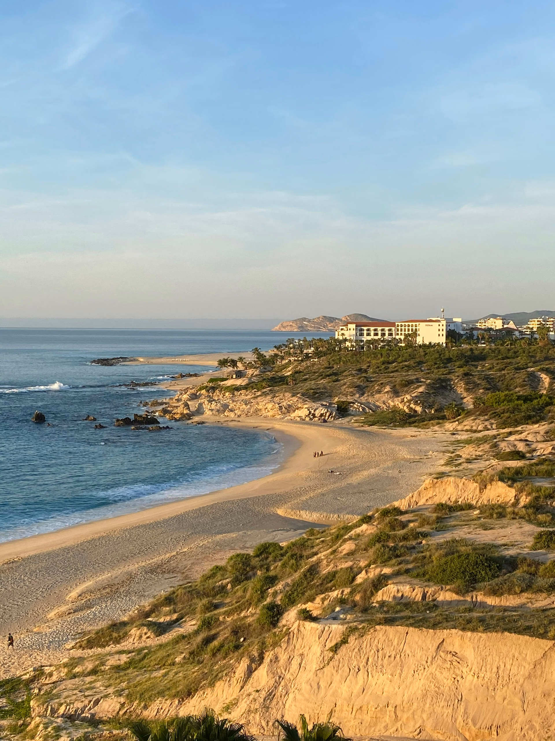 Aerial view of Los Cabos coastline with white buildings along a turquoise bay, Las Ventanas al Paraíso setting, Los Cabos